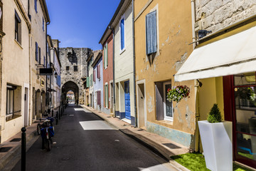 Fototapeta na wymiar Narrow street with colorful houses and bicycle at Aigues-Mortes southern France