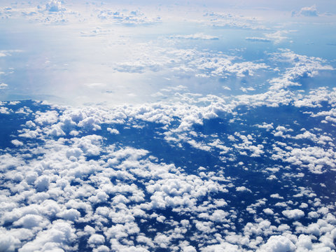 Mid-level cloudscape altocumulus white clouds. Altocumulus middle-altitude cloud in stratocumuliform. View from airplane white flying over sky.