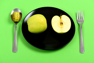 Dish for vegetarian lunch holding half and whole green apple