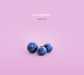 Creative layout made of blueberries. Flat lay. Food concept. Blueberry on purple background