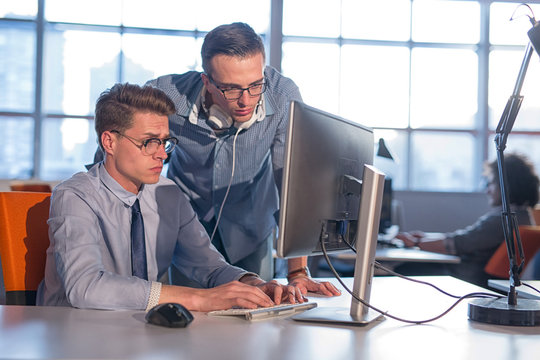 Two Business People Working With computer in office