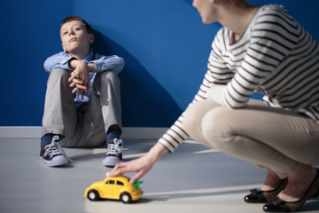 Mom playing with autistic son