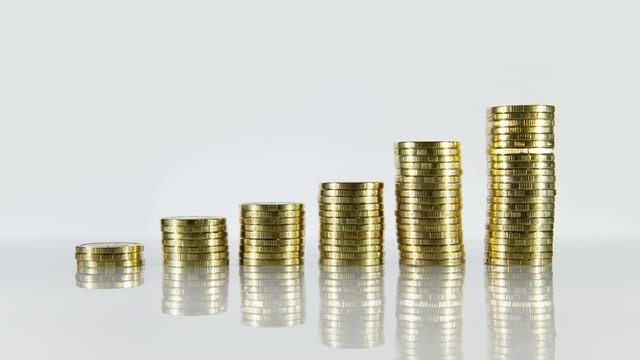 Growth of coins. Brilliant coins appear and grow. Well suited for the image of financial growth or profit.