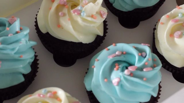 Decorating cup-cake with cream. Culinary master class design cupcakes, cream cupcakes from the pastry bag. Using cooking bag, confectioner making multicolor cupcakes for birthday party. HD
