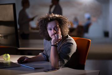 man working on computer in dark office