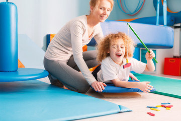 Kid playing with physiotherapist