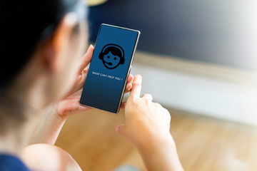 Woman hold smart phone use application chat bot.