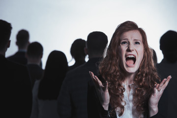 Screaming woman standing in crowd