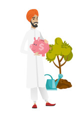 Hindu farmer holding a piggy bank.