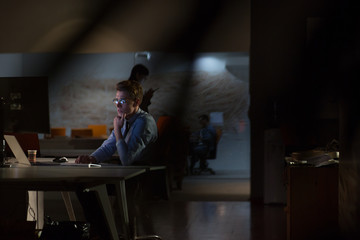 man working on computer in dark office