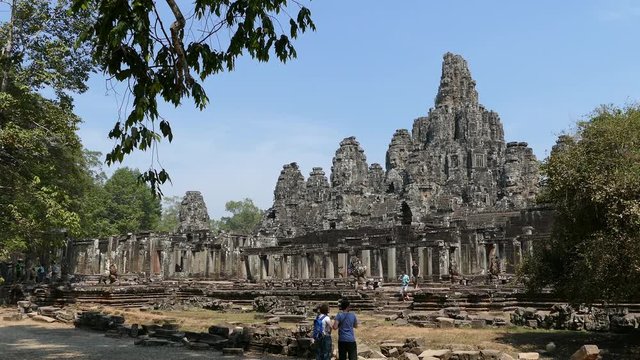 Tourists making a photo from Bayon Khmer temple at Angkor Wat Cambodia