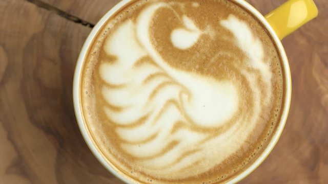 Swan latte art, top view. Texture of coffee foam. Coffee shop advertising.