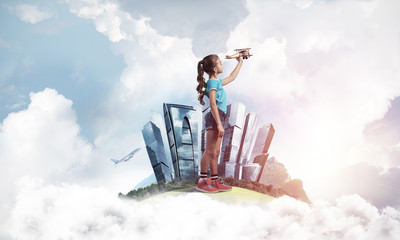 Concept of careless happy childhood with girl dreaming to become