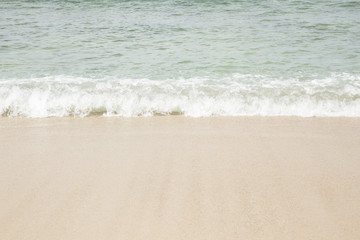The background of sea waves, clear emerald beach with pure white sand.