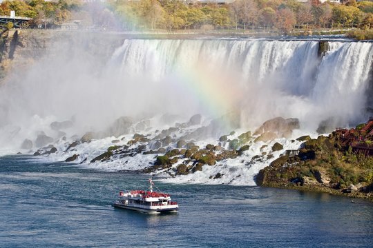 Beautiful image with amazing Niagara waterfall, rainbow, and a ship