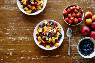 healthy organic fresh breakfast cereal with seasonal fruits on vintage table