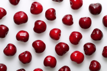 Red ripe sweet cherries on a white background