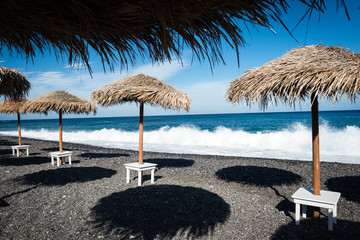 Umbrellas on the empty beach in Santorini, Greece. Idyllic travel background © ventura