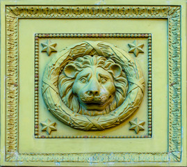 Ancient curly head of a lion on a door.