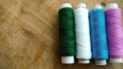 Multicolor sewing threads on white background 