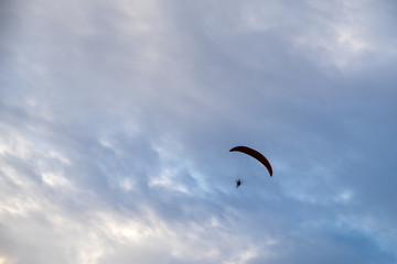 silhouette paramotor flying in the sky