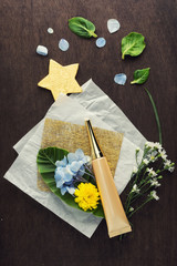 flat lay moisturizer eye serum with flowers on craft paper