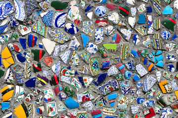 Wall with broken ceramic plates colored fragments 
