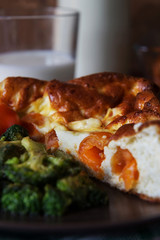 Baked omelet with tomatoes and broccoli close-up