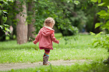 Little beautiful girl walking in a summer park