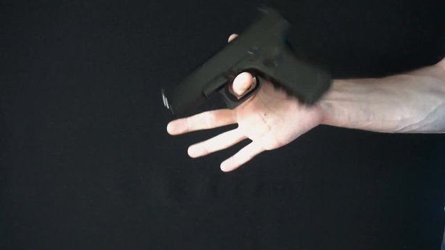 the young man turns on his finger gun black.slow motion