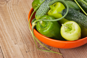 green peppers, cucumbers and garlic in a bowl