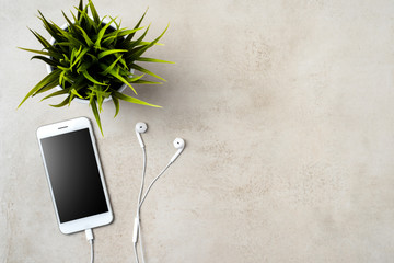Modern white smartphone on grey stone table