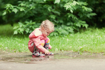 Little beautiful girl walking in a summer park