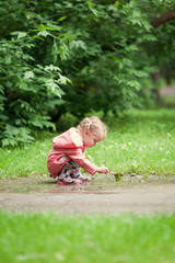 Little beautiful girl walking in a summer park