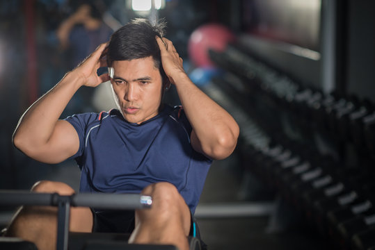 Asian Man Doing Sit-ups At Gym.