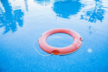 red life preserver on the pool water