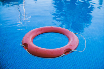 red life preserver on the pool water