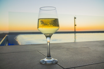 a glass of wine at sunset