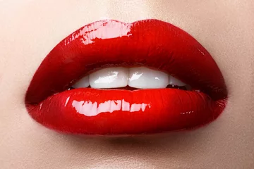 Fotobehang Close-up of woman's lips with bright fashion red glossy makeup. Macro bloody lipgloss make-up © garneg