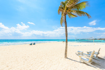 Fototapeta na wymiar Relaxing on chair at paradise beach and city at caribbean coast of Quintana Roo, Mexico