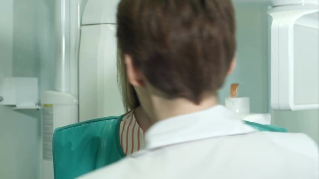 Young attractive female patient being prepared for dental X-Ray scan