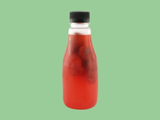 single strawberry juice in transparent plastic bottle isolated on green