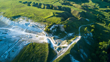 View  from the top on the chalky quarry and a beautiful landscape with meadows, hills and trees