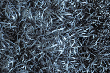 Metal shavings in the metal-working factory. Abstract metal background with filter color.