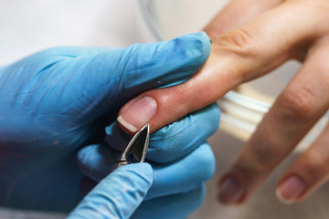Manicure process in beauty salon, close up