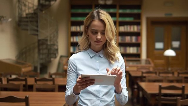 Student works with tablet in the library