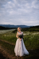 Fototapeta premium Beautiful woman enjoying daisy field, nice female lying down in meadow of flowers, pretty girl relaxing outdoor, having fun, happy young lady and spring green nature, harmony concept