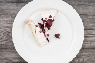 Cake on plate on wooden background.