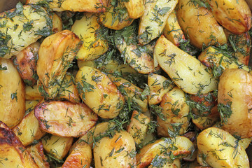 Slices of potatoes appetizing fried and sprinkled with herbs. A simple, beautiful dish prepared...