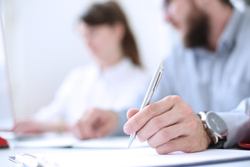 Businessman holding pen in hand